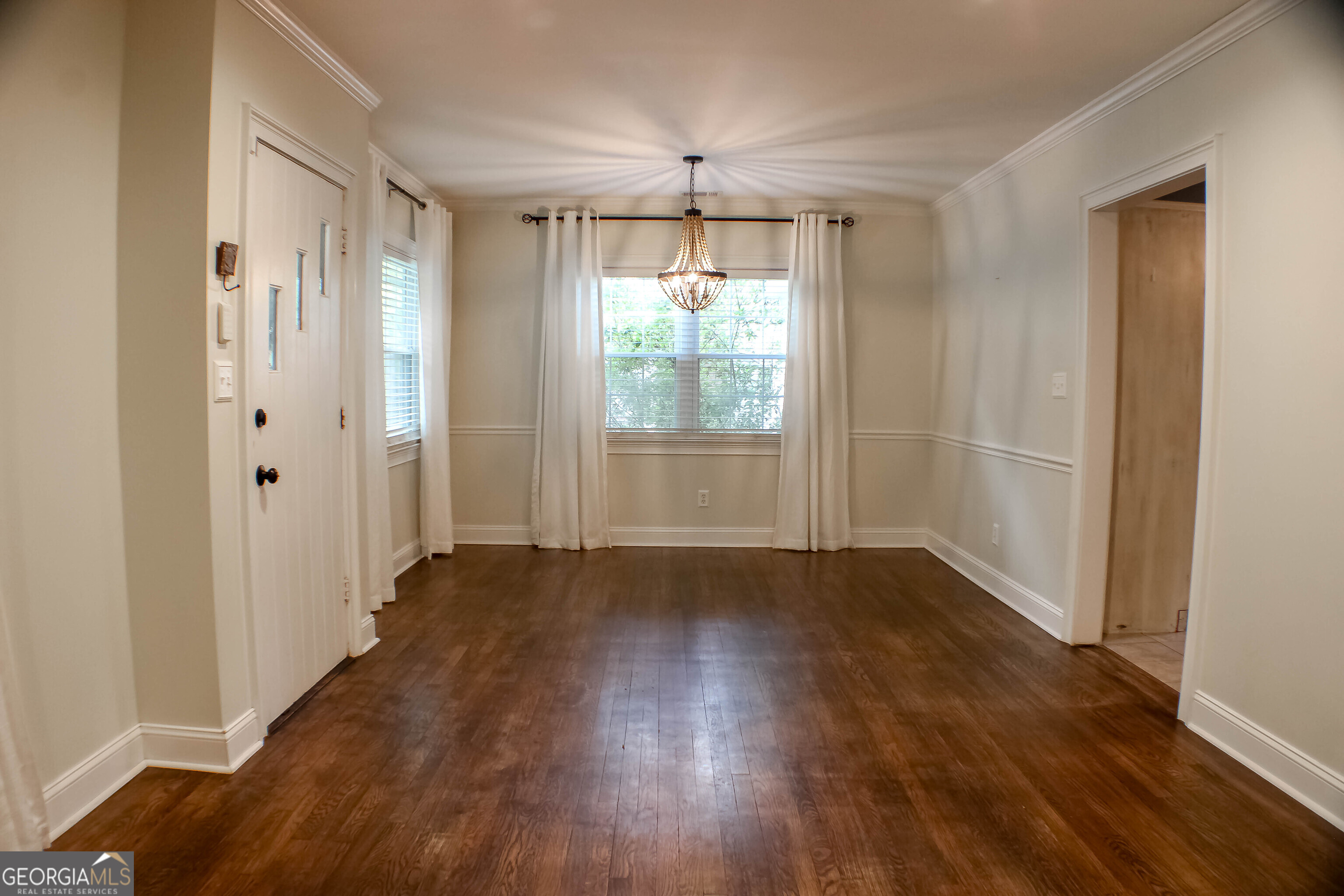 311 Roswell Avenue Southeast Rome, GA 30161 - Photo 5 of 21 an empty room with wooden floor and windows