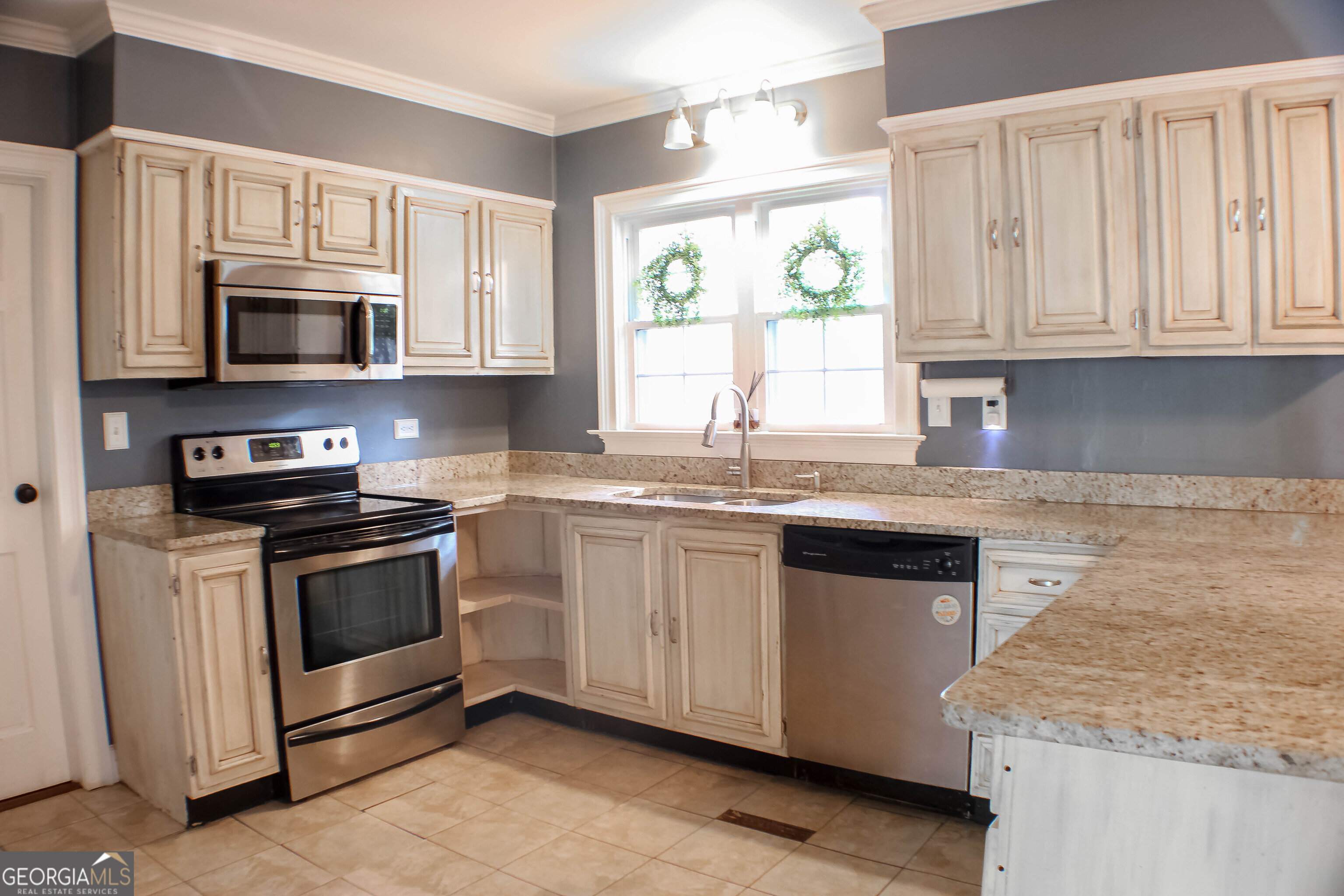311 Roswell Avenue Southeast Rome, GA 30161 - Photo 7 of 21 a kitchen with stainless steel appliances granite countertop white cabinets a sink and a stove