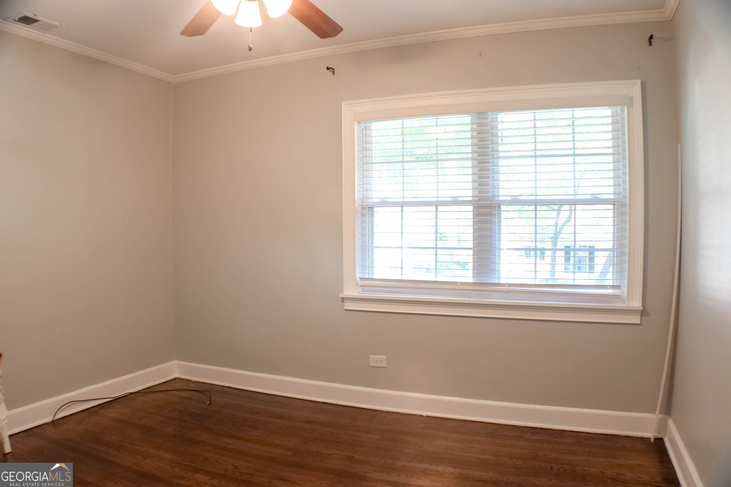 311 Roswell Avenue Southeast Rome, GA 30161 - Photo 10 of 21 an empty room with wooden floor and windows