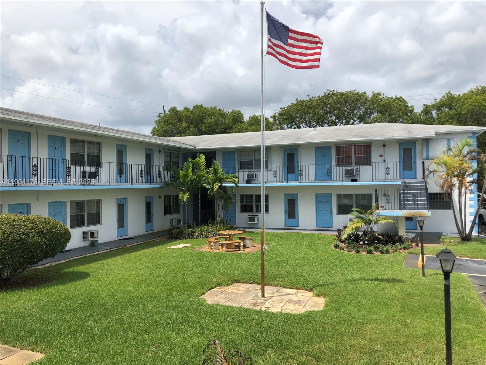 a front view of a house with a yard fire pit table and chairs