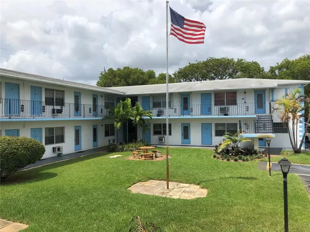 a front view of a house with a yard fire pit table and chairs