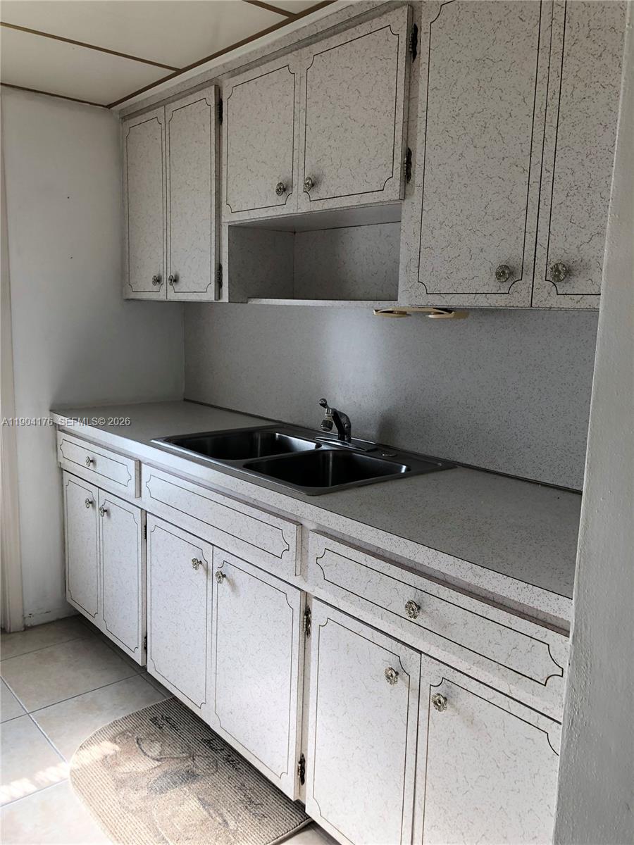 1836 Arthur Street, Unit 20 Hollywood, FL 33020 - Photo 14 of 19 a kitchen with white cabinets