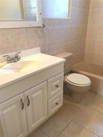 a bathroom with a toilet and bathtub