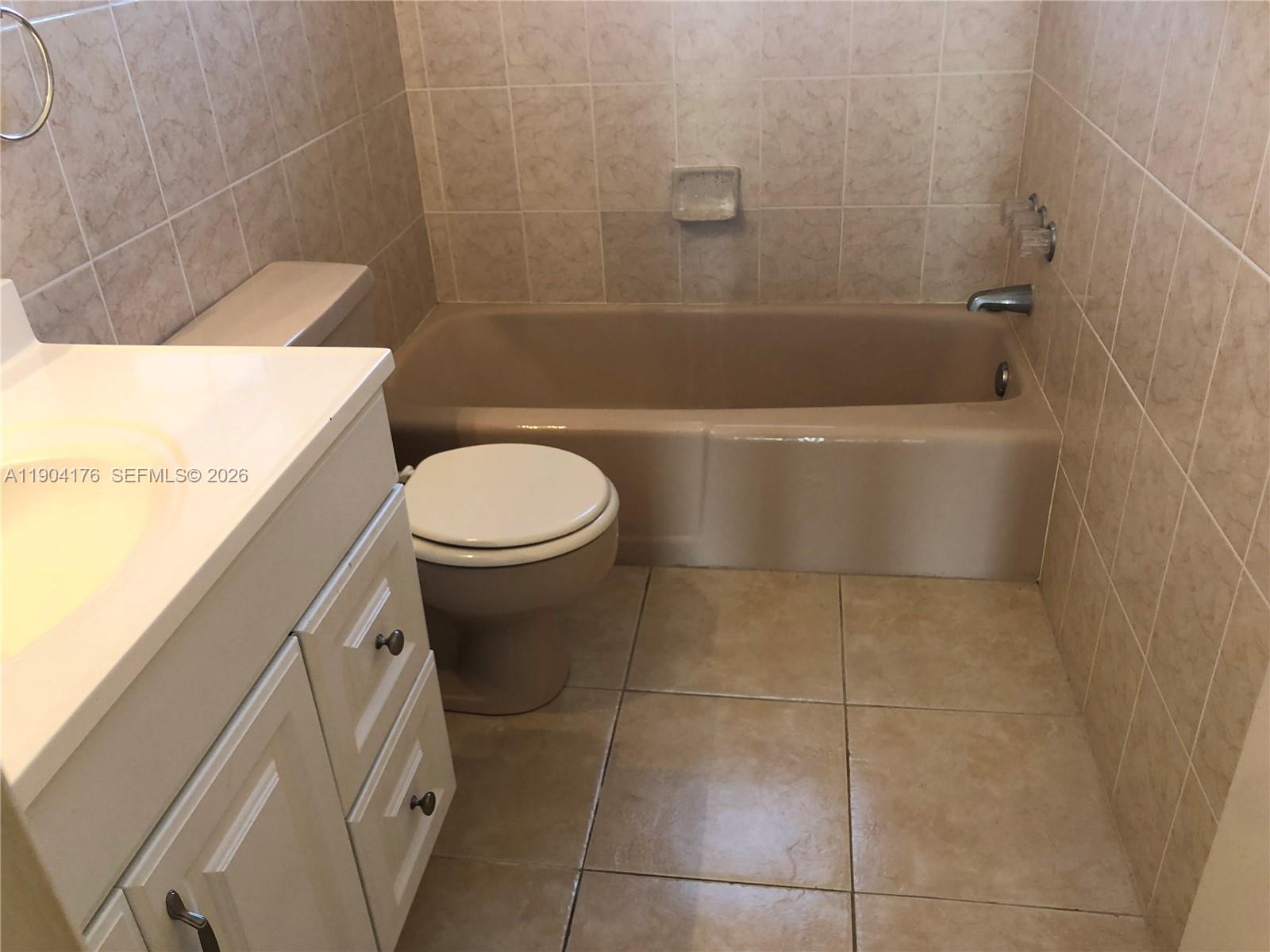 1836 Arthur Street, Unit 20 Hollywood, FL 33020 - Photo 16 of 19 a bathroom with a toilet and bathtub