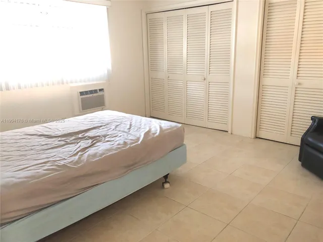 a bedroom with a bed and a television