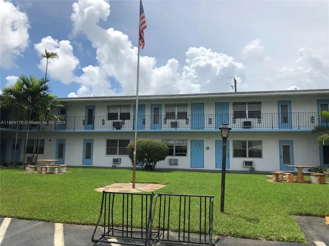 a front view of a house with a yard table and chairs