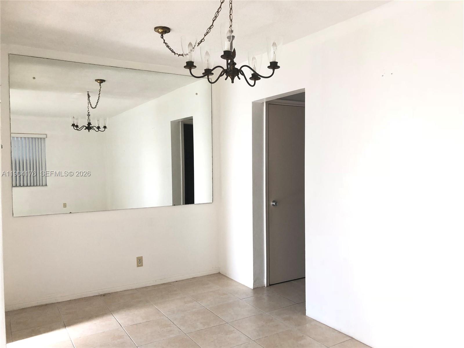 1836 Arthur Street, Unit 20 Hollywood, FL 33020 - Photo 10 of 19 a view of a hallway with chandelier and entryway