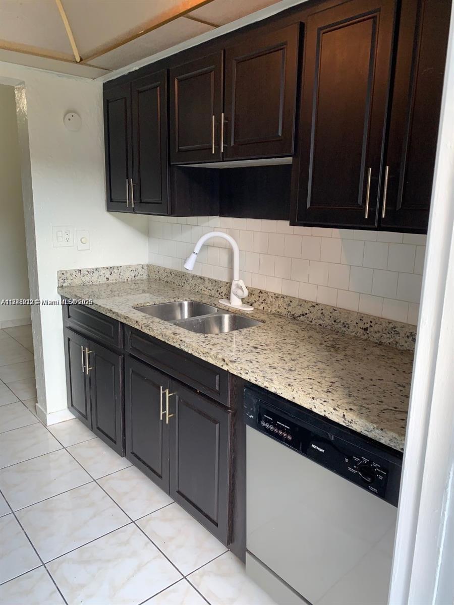 1850 Arthur Street, Unit 2 Hollywood, FL 33020 - Photo 2 of 20 a kitchen with granite countertop a sink and a stove