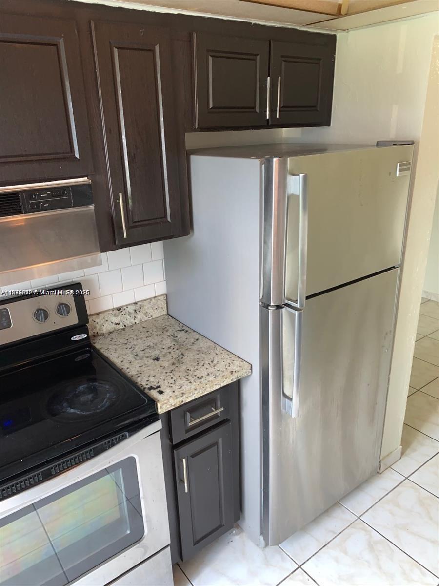 1850 Arthur Street, Unit 2 Hollywood, FL 33020 - Photo 3 of 20 a kitchen with stainless steel appliances granite countertop a refrigerator stove and microwave