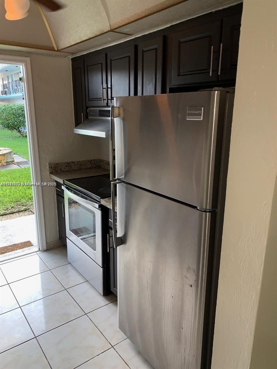 1850 Arthur Street, Unit 2 Hollywood, FL 33020 - Photo 5 of 20 a kitchen with a refrigerator and a stove