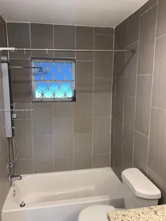 a bathroom with a toilet and bathtub
