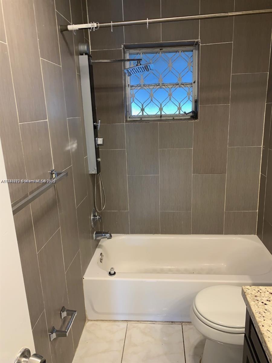 1850 Arthur Street, Unit 2 Hollywood, FL 33020 - Photo 8 of 20 a bathroom with a bathtub and a toilet