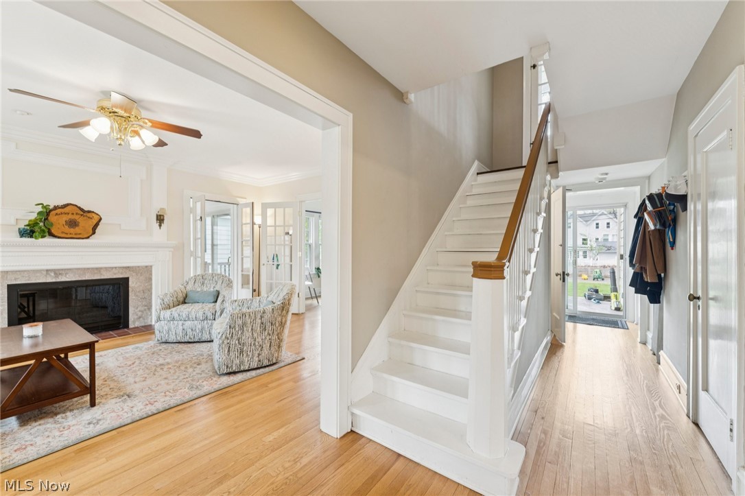 2925 East Overlook Road Cleveland Heights, OH 44118 - Photo 2 of 48 Inviting entryway with hardwood floors and a white staircase with a wooden handrail
