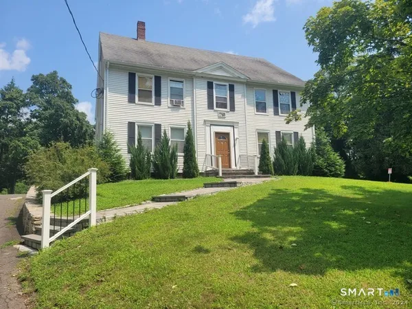 a front view of house with yard and green space