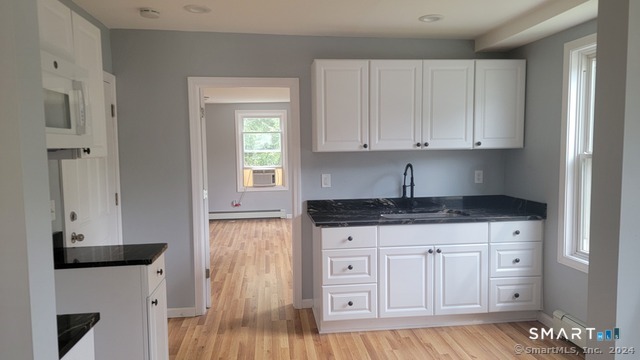 2 Center Street, Unit A Andover, CT 06232 - Photo 2 of 8 a kitchen with granite countertop a sink and cabinets