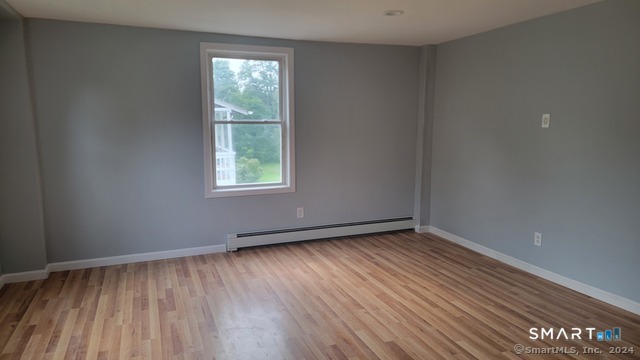 2 Center Street, Unit A Andover, CT 06232 - Photo 7 of 8 a view of an empty room with wooden floor and a window
