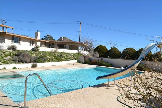 a view of a swimming pool with a lounge chairs