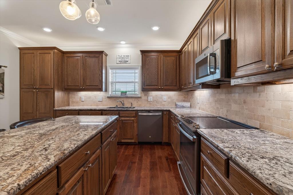 790 Bones Chapel Road Whitesboro, TX 76273 - Photo 33 of 39 a kitchen with stainless steel appliances granite countertop a sink stove and cabinets