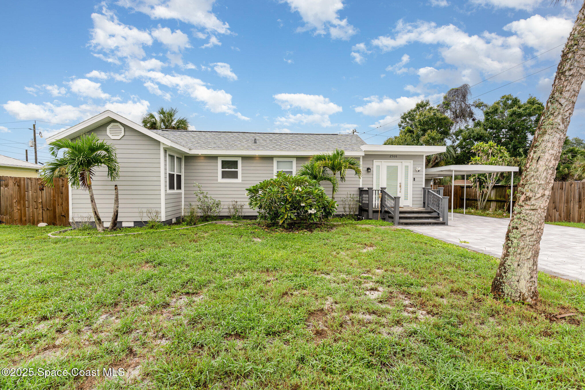2566 Spence Drive Northeast Palm Bay, FL 32905 - Photo 1 of 20 a view of a house with backyard and garden