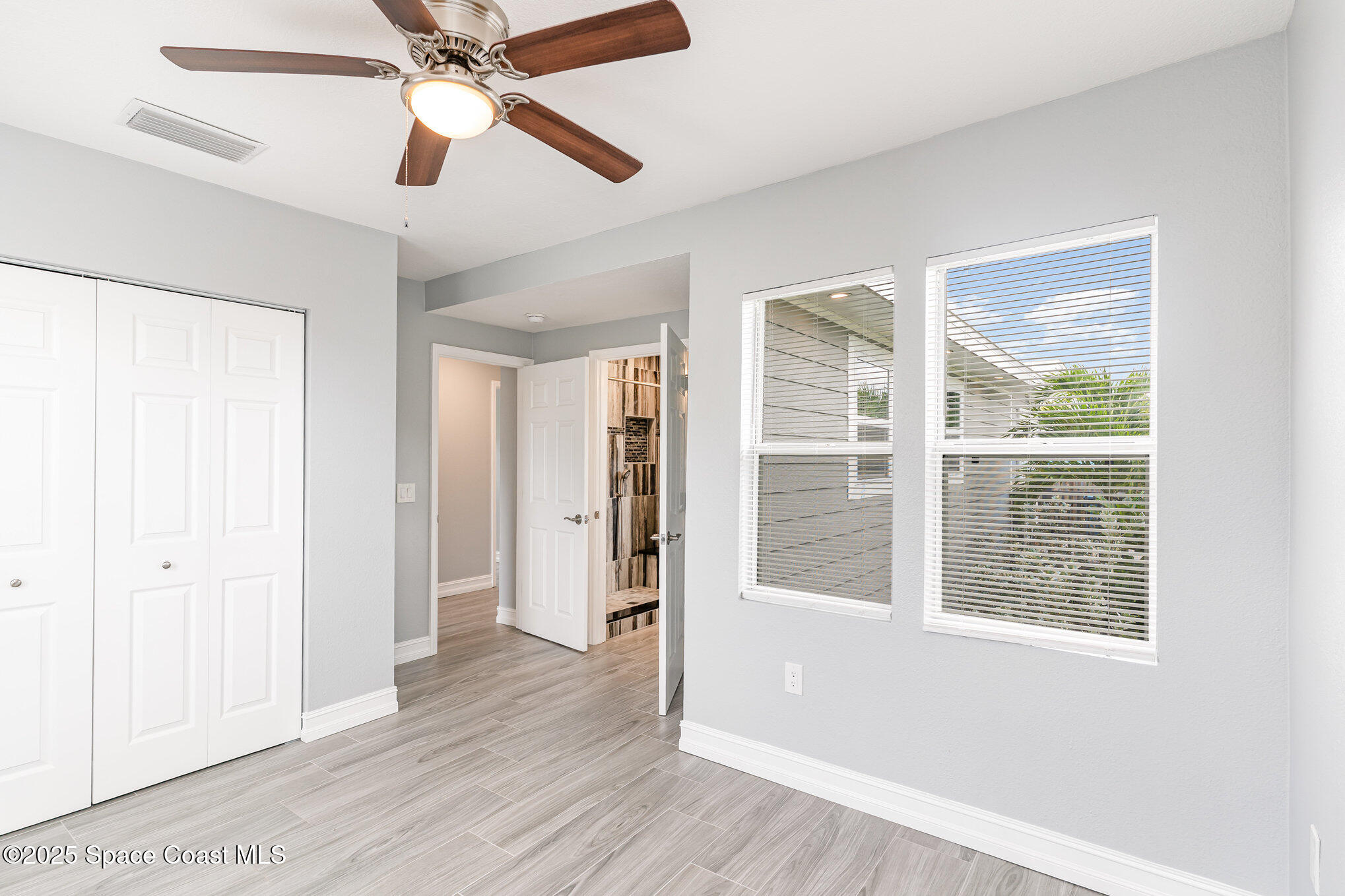 2566 Spence Drive Northeast Palm Bay, FL 32905 - Photo 11 of 20 a view of an empty room with wooden floor and a window