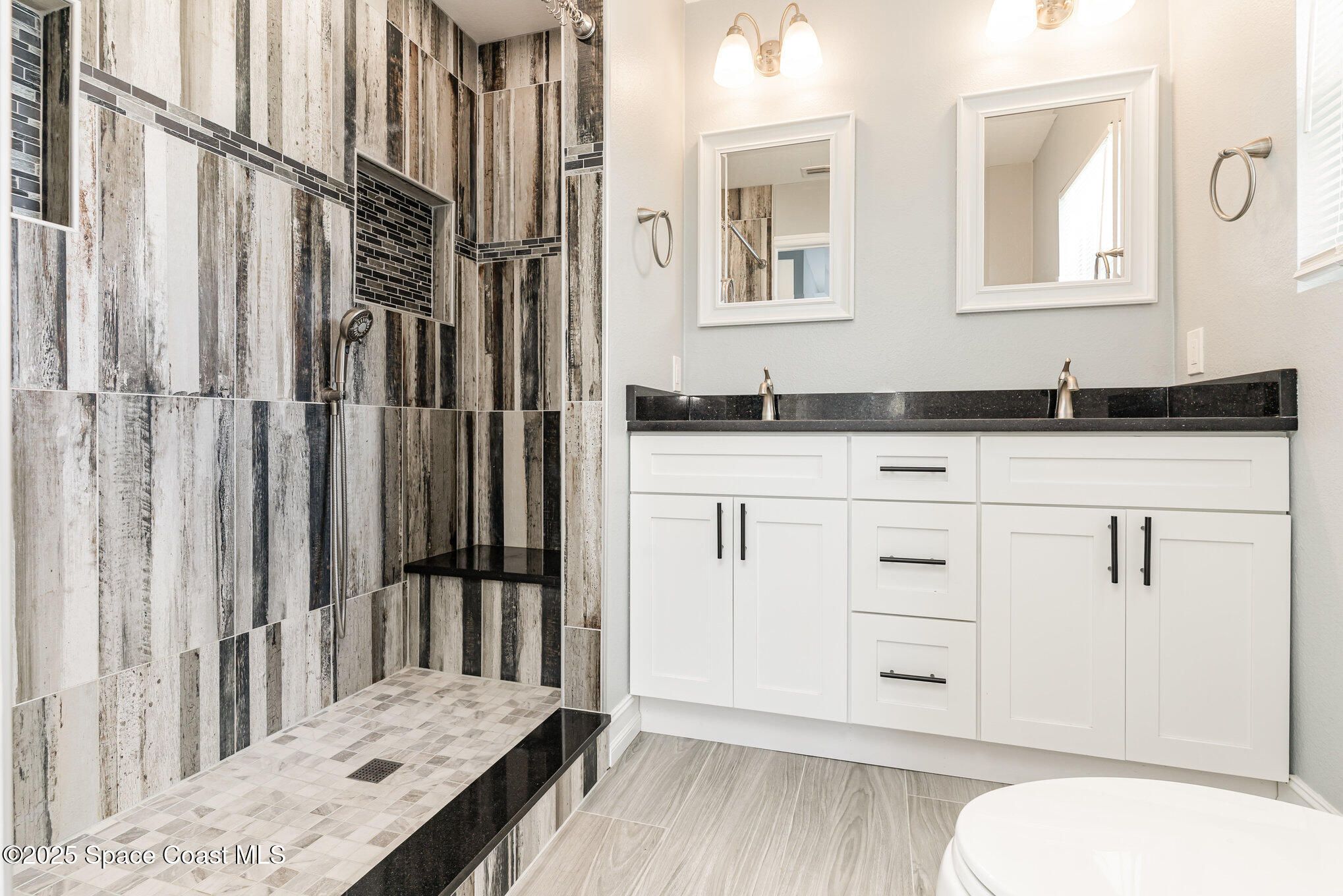 2566 Spence Drive Northeast Palm Bay, FL 32905 - Photo 12 of 20 a bathroom with a granite countertop sink and a mirror