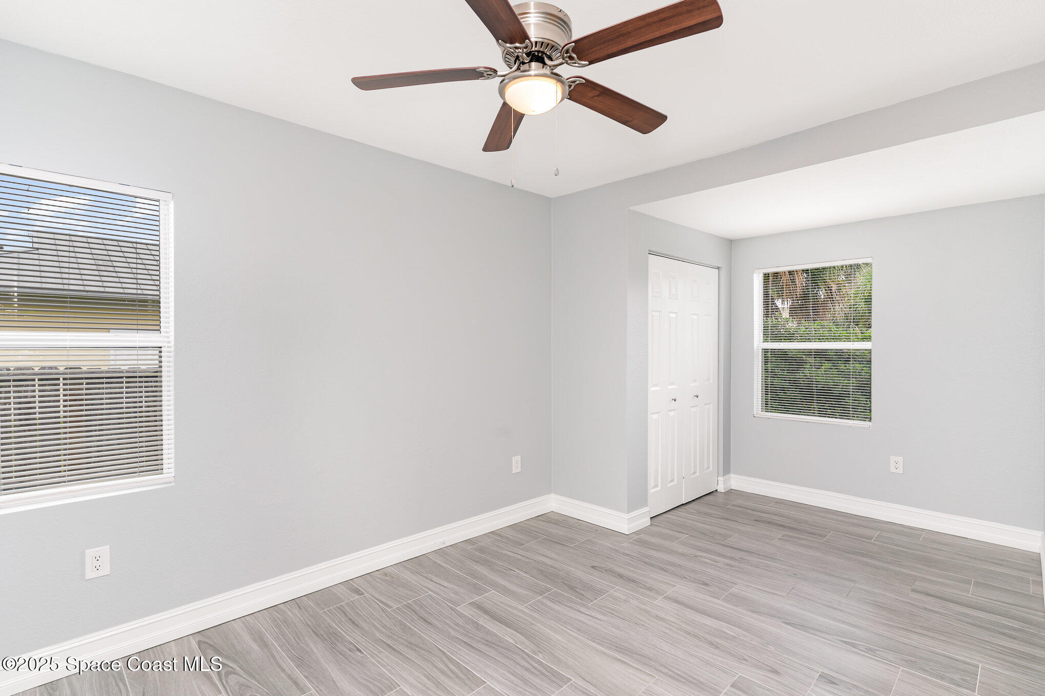 2566 Spence Drive Northeast Palm Bay, FL 32905 - Photo 15 of 20 a view of empty room with wooden floor and fan