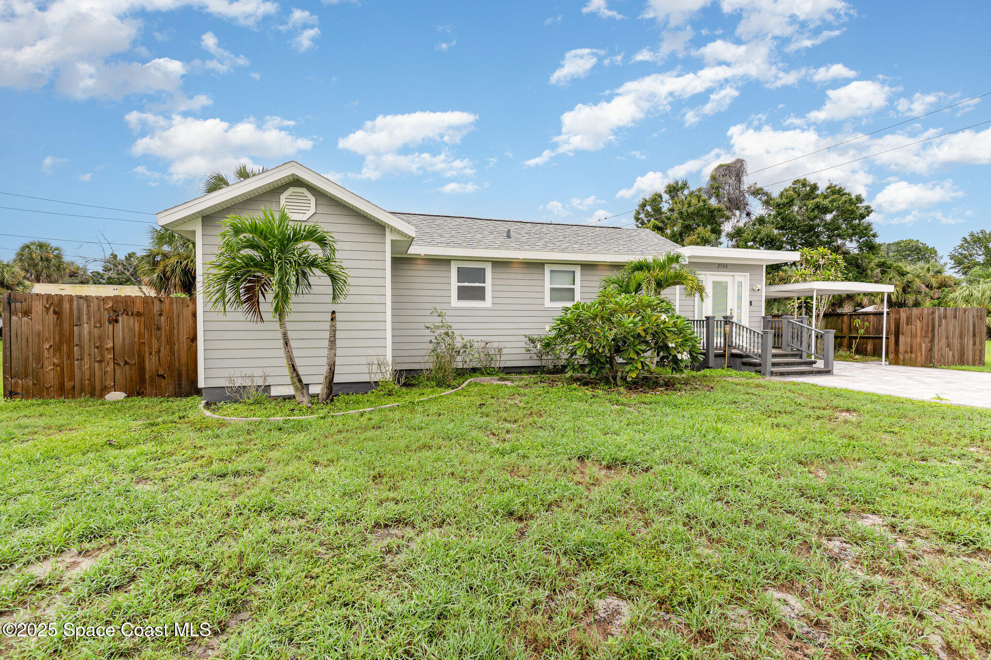 2566 Spence Drive Northeast Palm Bay, FL 32905 - Photo 2 of 20 a view of a house with backyard and garden