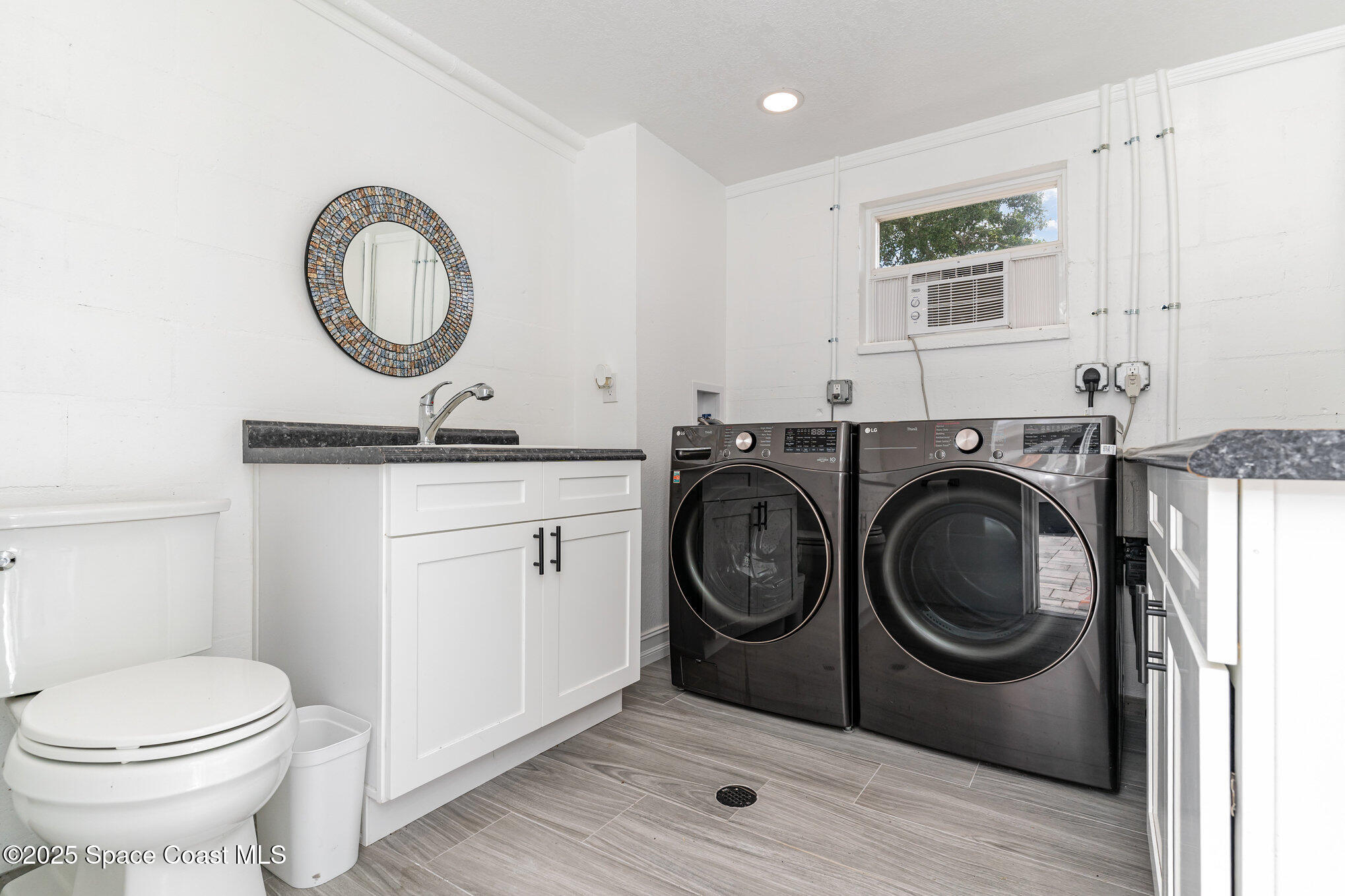 2566 Spence Drive Northeast Palm Bay, FL 32905 - Photo 9 of 20 a utility room with sink dryer and washer