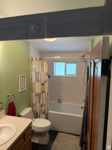 541 300 North Provo, UT 84606 - Photo 25 of 36 Bathroom featuring a single vanity with a white basin and a light-colored countertop, a white toilet, and a bathtub with a shower
