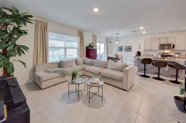 a living room with furniture and a large window