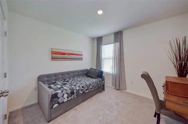 a bedroom with a bed and a chair