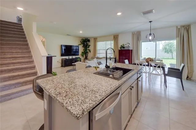 a kitchen with sink table and chairs
