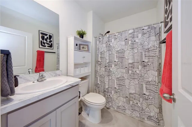 a bathroom with a sink mirror vanity and toilet