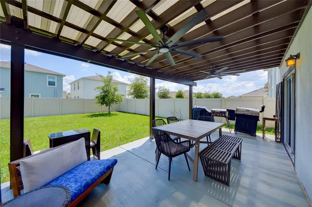 a view of a patio with a dining table and chairs with a garden