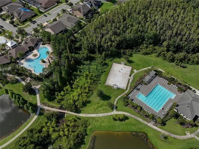 an aerial view of house with yard swimming pool and outdoor seating