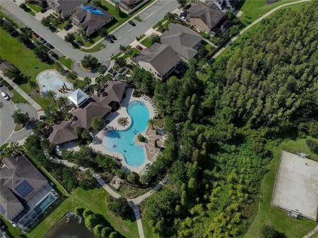 an aerial view of a house with a yard and outdoor space