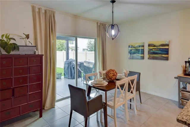 a dining room with furniture a chandelier and window