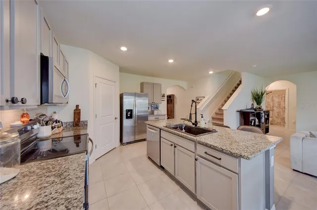 a kitchen with stainless steel appliances granite countertop a sink and a stove