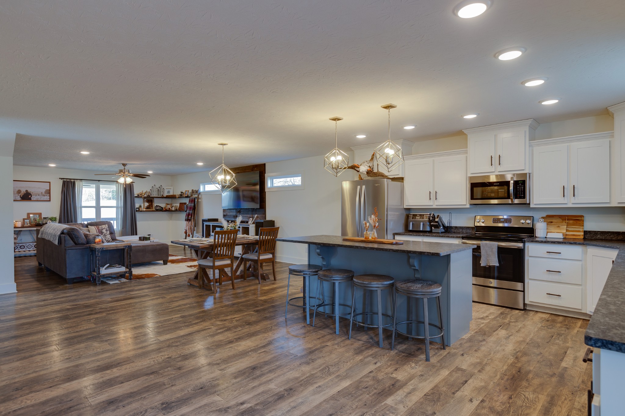 500 Armstrong Road Castalian Springs, TN 37031 - Photo 12 of 35 a kitchen with stainless steel appliances kitchen island granite countertop a table chairs sink and cabinets