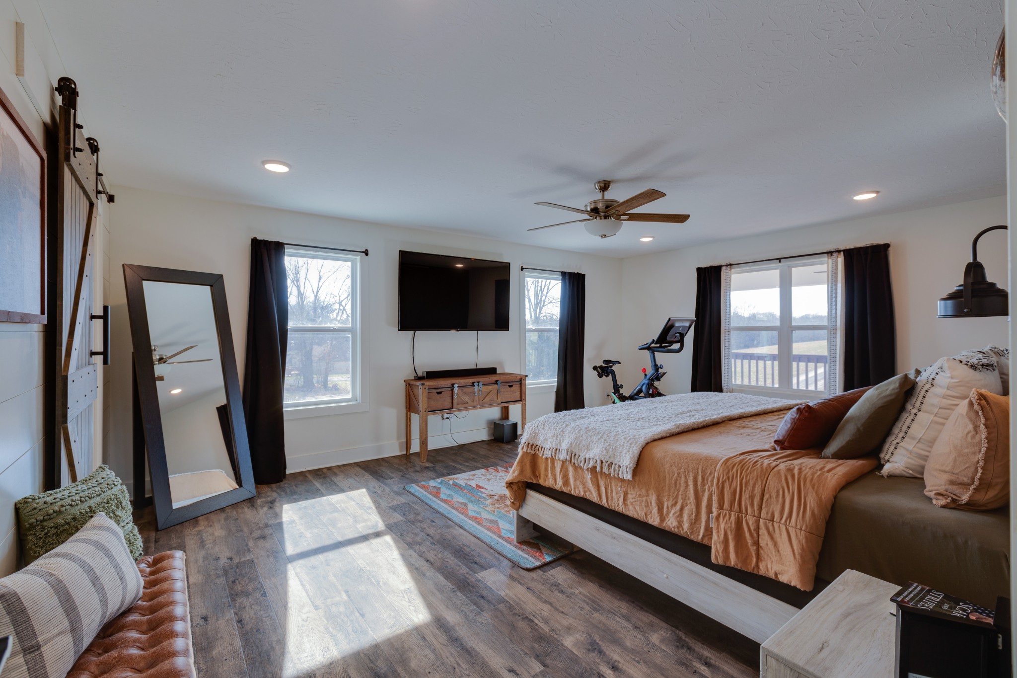 500 Armstrong Road Castalian Springs, TN 37031 - Photo 17 of 35 a bedroom with a large bed a flat tv screen and a dresser
