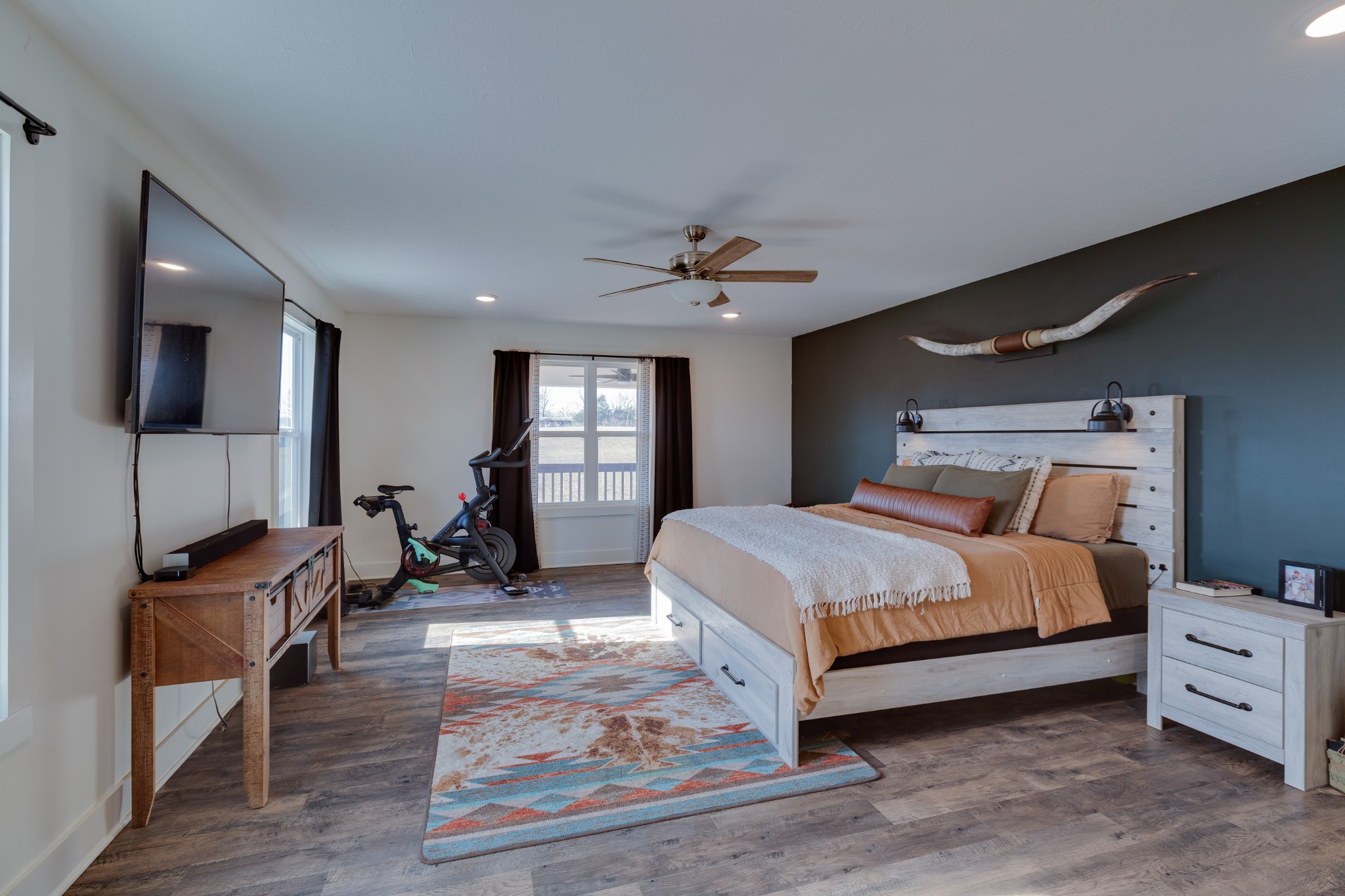 500 Armstrong Road Castalian Springs, TN 37031 - Photo 18 of 35 a spacious bedroom with a bed a couch and a flat tv screen on the dresser