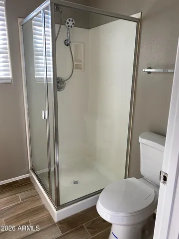 a bathroom with a toilet and a shower