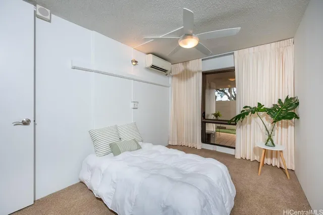 a bedroom with a bed and a potted plant