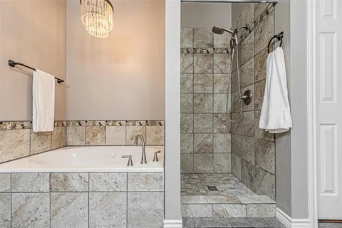 a bathroom with a bathtub and shower