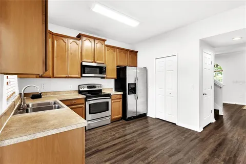 a kitchen with stainless steel appliances granite countertop a sink stove and microwave