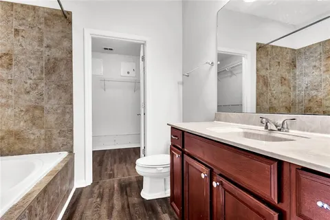 a bathroom with a sink a toilet and mirror