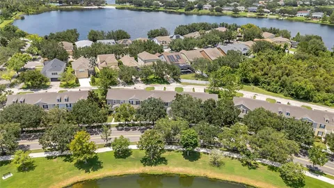 an aerial view of a house with a lake view