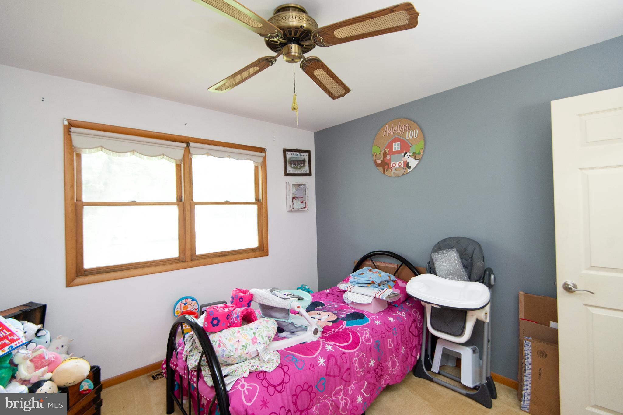 5802 Phyllis Drive Hurlock, MD 21643 - Photo 17 of 26 a bedroom with a bed and a chandelier