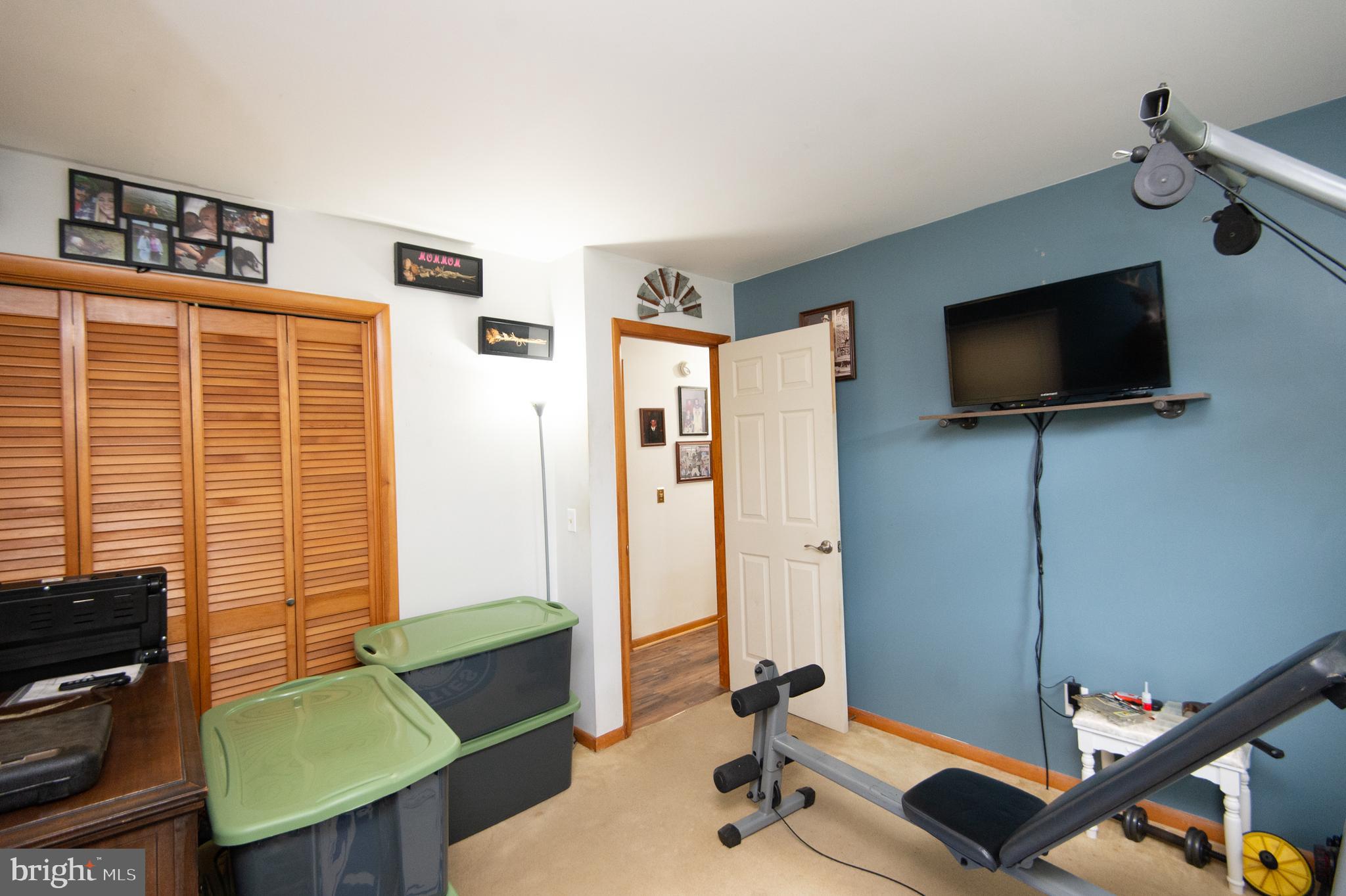5802 Phyllis Drive Hurlock, MD 21643 - Photo 18 of 26 a living room with furniture and a flat screen tv
