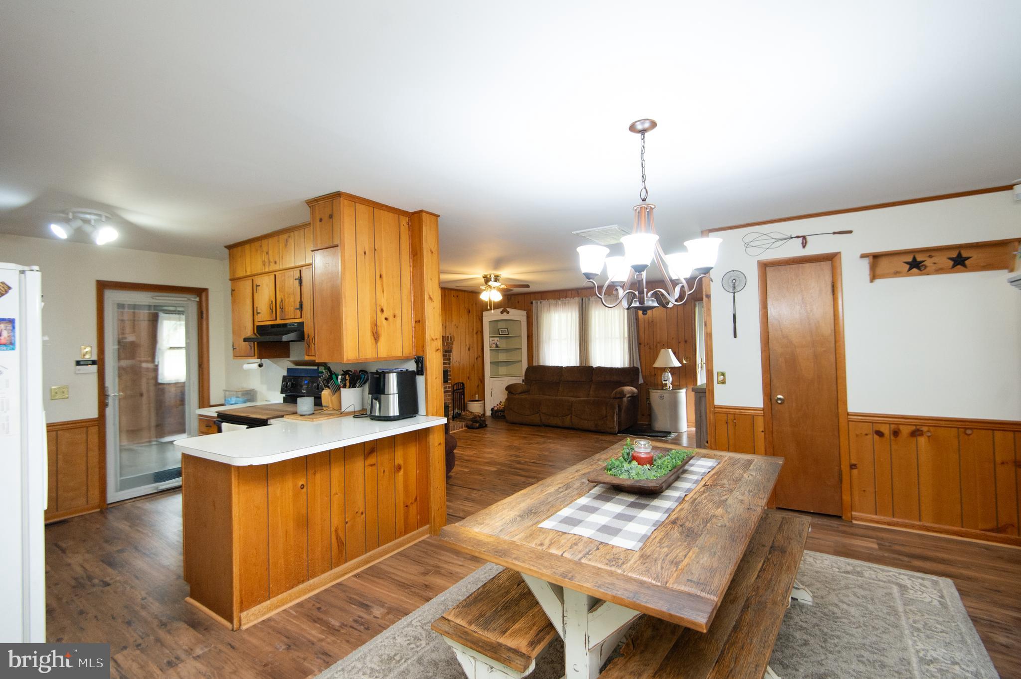 5802 Phyllis Drive Hurlock, MD 21643 - Photo 9 of 26 a kitchen with sink refrigerator and dining table